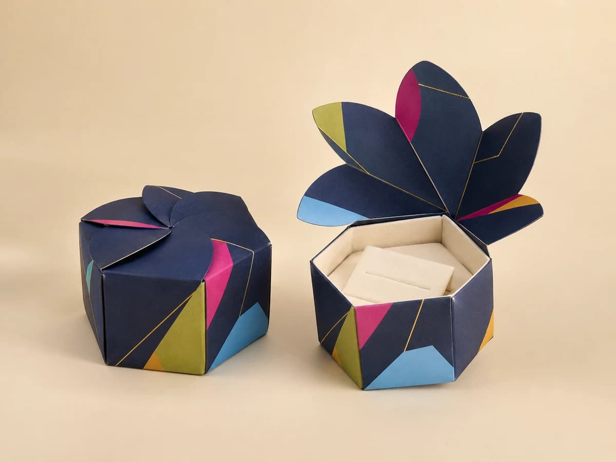 Hexagonal navy jewellery box with interlocking flower-style top shown closed and open